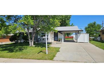 Charming home featuring a covered carport, front patio, and mature landscaping at 8610 Jolene Dr, Denver, CO 80229