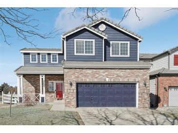 Charming two-story home with brick and siding and attached two-car garage at 24603 E Louisiana Cir, Aurora, CO 80018