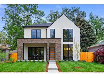Modern two-story home with white siding, brick accents, and large windows, set on a green lawn at 1126 S Garfield St, Denver, CO 80210