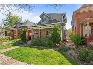 Charming two-story home featuring a stone facade, landscaped front yard, and inviting covered porch at 3354 Vallejo St, Denver, CO 80211