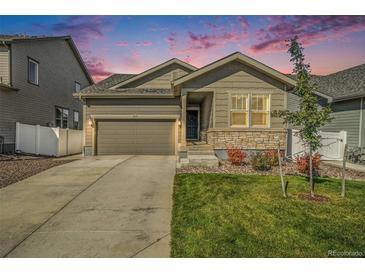 Two-story house with gray siding, stone accents, and a two-car garage at 2237 Barela Dr, Berthoud, CO 80513