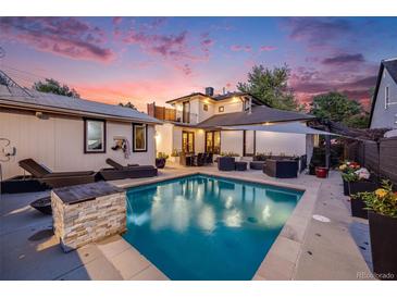Stunning backyard pool area with lounge seating, an outdoor dining set, and lush landscaping, perfect for entertaining at 1609 S Clayton St, Denver, CO 80210