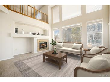 Living room with high ceilings, hardwood floors, and a fireplace at 11729 Elmer Linn Dr, Longmont, CO 80504