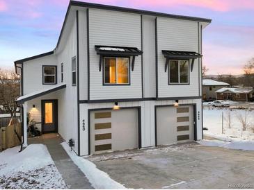 Modern two-unit building with attached garages and snow-covered driveway at 4660 W 9Th Ave, Denver, CO 80204