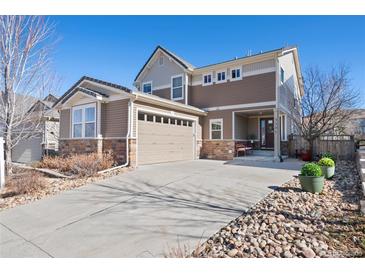 Charming two-story home featuring a welcoming entrance, a spacious driveway, and a well-manicured front yard at 3395 Starry Night Loop, Castle Rock, CO 80109