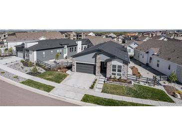 Beautiful single-Gathering home with stone accents, well-maintained landscaping, and a two-car garage in a peaceful neighborhood at 7169 Canyon Sky Trl, Castle Pines, CO 80108