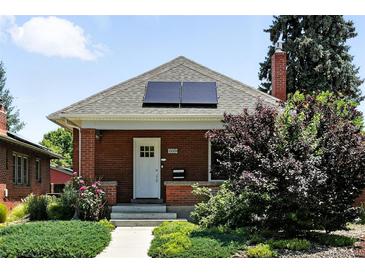 Charming brick home with solar panels, well-maintained landscaping, and a welcoming front entrance at 2660 Julian St, Denver, CO 80211