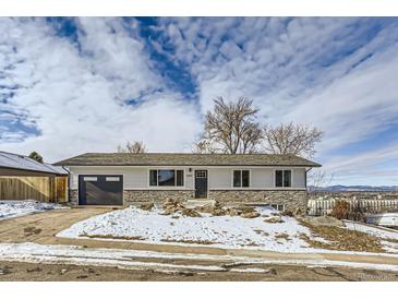 Ranch style home with stone accents and a two-car garage at 4501 S Lipan Ct, Englewood, CO 80110