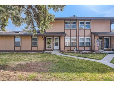 Inviting townhouse featuring a well-maintained lawn and charming exterior details at 3706 S Fairplay Way, Aurora, CO 80014