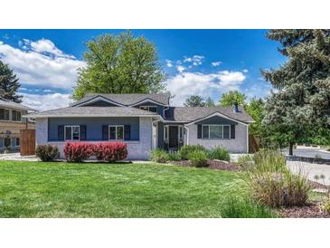 Charming single-Gathering home with light brick, lush landscaping, and mature trees under a partly cloudy blue sky at 5071 S Boston St, Greenwood Village, CO 80111