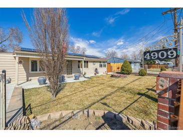 Ranch home featuring solar panels and low maintenance yard with a fire pit at 4909 W Mississippi Ave, Denver, CO 80219