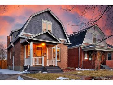 Charming two-story brick home with a covered front porch and inviting curb appeal at 608 S Grant St, Denver, CO 80209