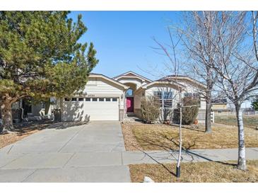 Charming ranch-style home with a two-car garage and a well-manicured front yard at 24783 E Arkansas Pl, Aurora, CO 80018