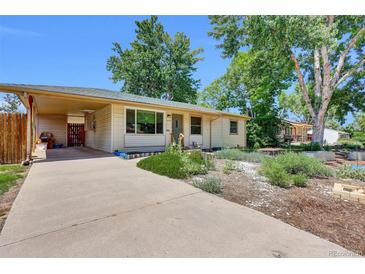 Charming single-story home with a covered parking and well-kept landscaping at 1225 S Honey Way, Denver, CO 80224