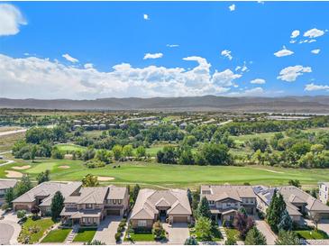 Aerial view of homes with mountain views and golf course at 9005 Stonecrest Way, Highlands Ranch, CO 80129