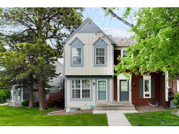 Charming two-story townhome with light-colored siding, gray trim and a well-maintained lawn at 9946 W Cornell Pl, Lakewood, CO 80227