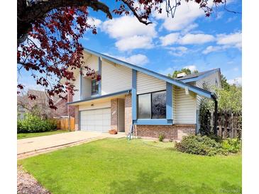 Two story home boasts a modern exterior with a well-maintained lawn and attached garage at 8133 W Quarto Ave, Littleton, CO 80128