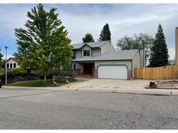 Two-story house with attached garage and landscaped yard at 3136 S Cathay Cir, Aurora, CO 80013