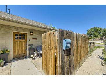 Charming front yard with a wooden fence, inviting entrance and a glimpse of neighborhood charm at 2841 N Columbine St, Denver, CO 80205