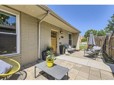 Charming front yard with stylish outdoor seating, decorative plants, and a brick facade at 2841 N Columbine St, Denver, CO 80205