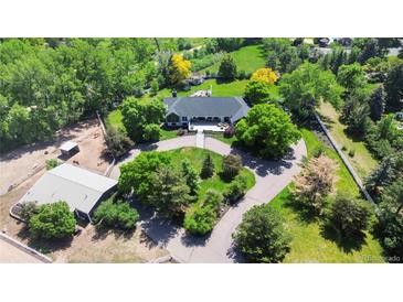 Expansive property with mature trees and well-maintained landscaping on a sprawling lot at 5700 S University Blvd, Greenwood Village, CO 80121