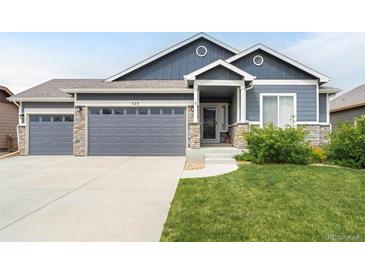 Charming single-Gathering home featuring a 3-car garage and a beautifully landscaped front yard at 577 Tristan Pl, Berthoud, CO 80513