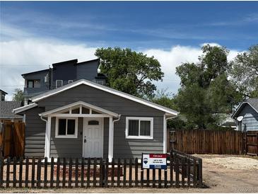 Charming single-story home with gray siding, a well-maintained yard, and a 'For Sale' sign at 1533 E Harlan, Lakewood, CO 80214