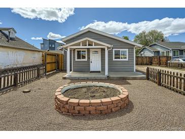 Charming home with a cozy front yard and a custom fire pit, perfect for outdoor entertaining at 1533 E Harlan, Lakewood, CO 80214