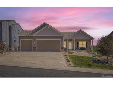 Charming single-Gathering home with a three-car garage, landscaped front yard, and inviting entrance at 5350 Clearbrooke Ct, Castle Rock, CO 80104