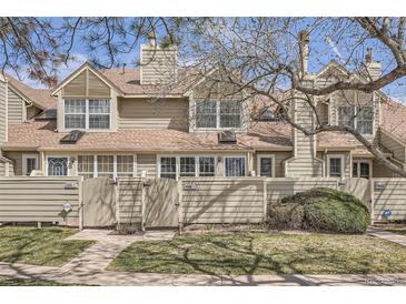Charming townhouse exterior featuring well-kept lawns and a private fenced entrance at 7373 E Iowa Ave # 1112, Denver, CO 80231