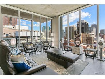 Bright and airy living room featuring expansive windows with stunning city views and sleek modern decor at 891 14Th St # 1408, Denver, CO 80202