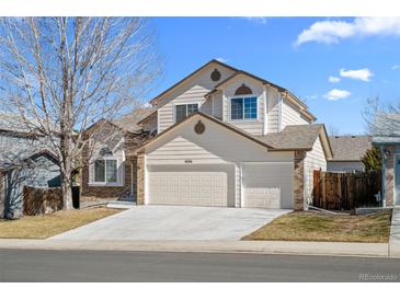 Charming two-story home with a well-maintained lawn, a two car garage, and a traditional design at 5276 S Danube St, Centennial, CO 80015