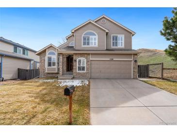 Charming two-story home with a well-manicured front yard and attached two-car garage at 11248 W Ford Dr, Lakewood, CO 80226