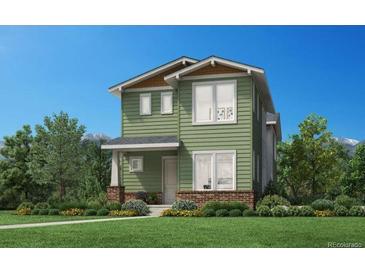 Charming two-story home with green siding, brick accents, and professionally landscaped front yard at 910 Promenade Dr, Superior, CO 80027