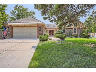 Brick ranch home with attached garage and landscaped lawn at 8272 Bighorn Ct, Lone Tree, CO 80124