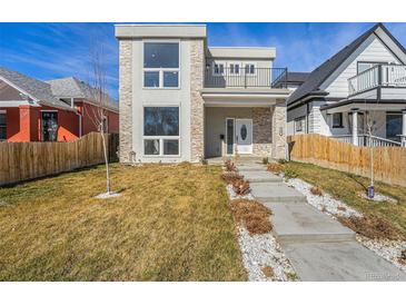 Modern two-story home with stone accents, balcony, xeriscaped front yard, and concrete steps at 2409 W 38Th Ave, Denver, CO 80211