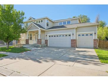 Charming two-story home with a three-car garage, covered porch, and well-maintained landscaping at 4844 Mt Evans St, Brighton, CO 80601