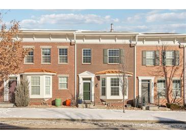 Brick townhome with a charming front porch and landscaping at 4321 W 118Th Pl, Westminster, CO 80031