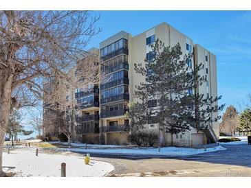Condo building exterior with landscaping and parking at 13601 E Marina Dr # 404, Aurora, CO 80014
