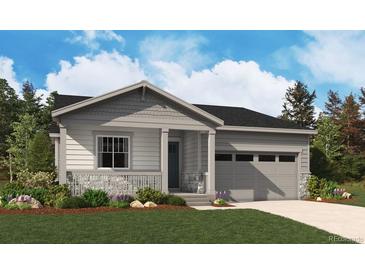 Charming single-story home with a gray exterior, stone accents, well-manicured lawn, and attached two-car garage at 24745 E 41St Ave, Aurora, CO 80019