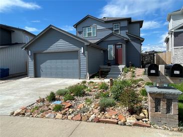 Charming two-story home with a well-maintained front yard and attached garage at 965 Arapahoe Cir, Louisville, CO 80027