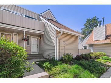Inviting home exterior featuring tidy landscaping and a covered porch area at 2491 S Xanadu Way # A, Aurora, CO 80014