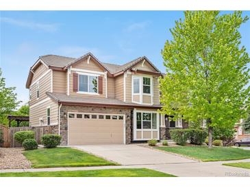 Charming two-story home with a manicured lawn, stone accents, and a two-car garage at 23870 E Dorado Pl, Aurora, CO 80016