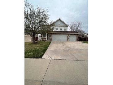 Charming two-story home with a three car garage and stone accents at 19193 E Amherst Dr, Aurora, CO 80013