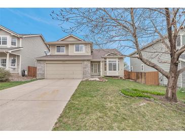 Charming two-story home with landscaped yard, attached two-car garage, and inviting curb appeal at 12047 W Coal Mine Dr, Littleton, CO 80127
