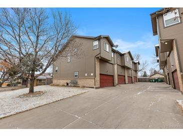 A nice view of multiple townhomes, each with private garages and appealing architecture at 6450 W 44Th Pl # B-3, Wheat Ridge, CO 80033