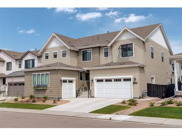 Beautiful two-story home featuring a manicured lawn, attached two car garage, and neutral colored siding at 11142 Bright Sky St, Littleton, CO 80125