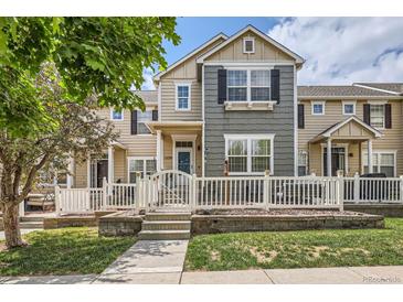 Charming townhome with a fenced front yard, well-manicured lawn, and inviting entrance at 1539 Bennet Mountain Rd, Castle Rock, CO 80109