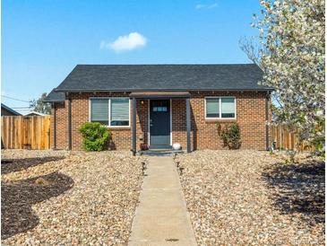 Charming brick home with a well-maintained front yard and inviting entrance at 3011 Oneida St, Denver, CO 80207