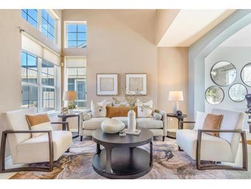 Bright and airy living room features large windows, neutral colors, and stylish furniture at 10935 Acadia, Parker, CO 80138